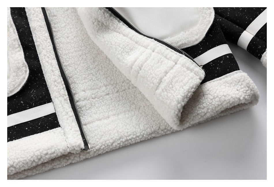 Close-up of a black speckled jacket with white fleece lining, trim and cuffs, and a front zipper.