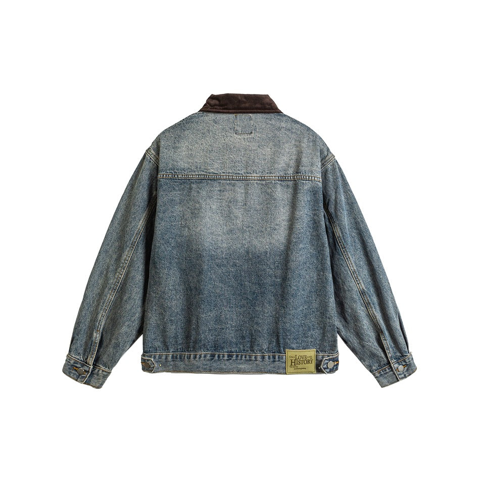 Back view of a blue washed denim jacket with a brown corduroy collar and buttoned cuffs.