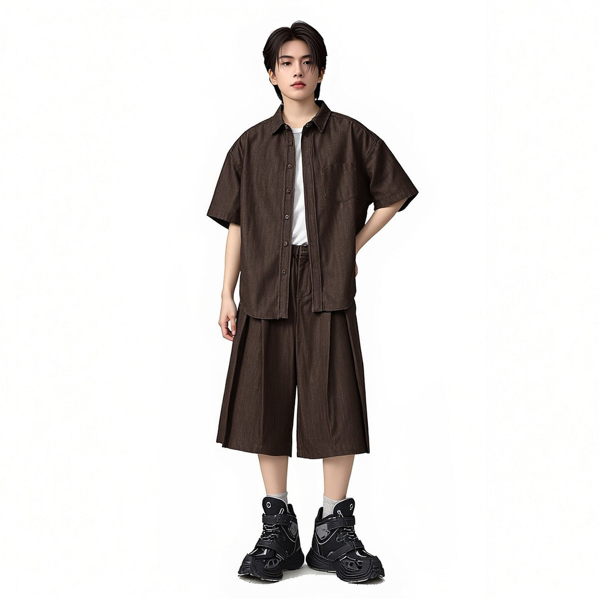 Model wearing a dark brown short-sleeve button-up shirt over a white tee with matching wide cropped pants.