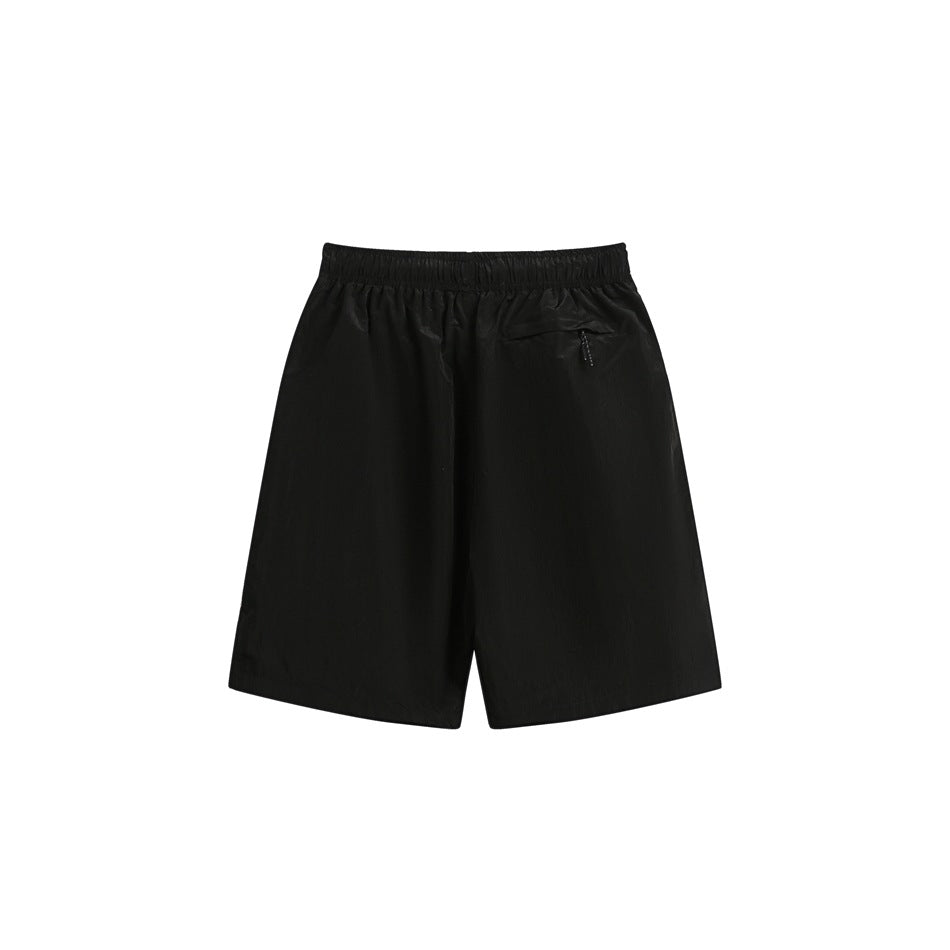 Black shorts shown from the back, with an elastic waistband and a small zip pocket.