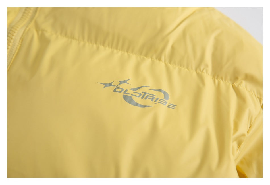 Close-up of a gray printed logo on the yellow jacket fabric.