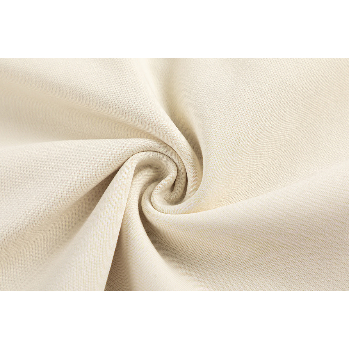 Close-up of cream-colored garment fabric gathered into a spiral fold.