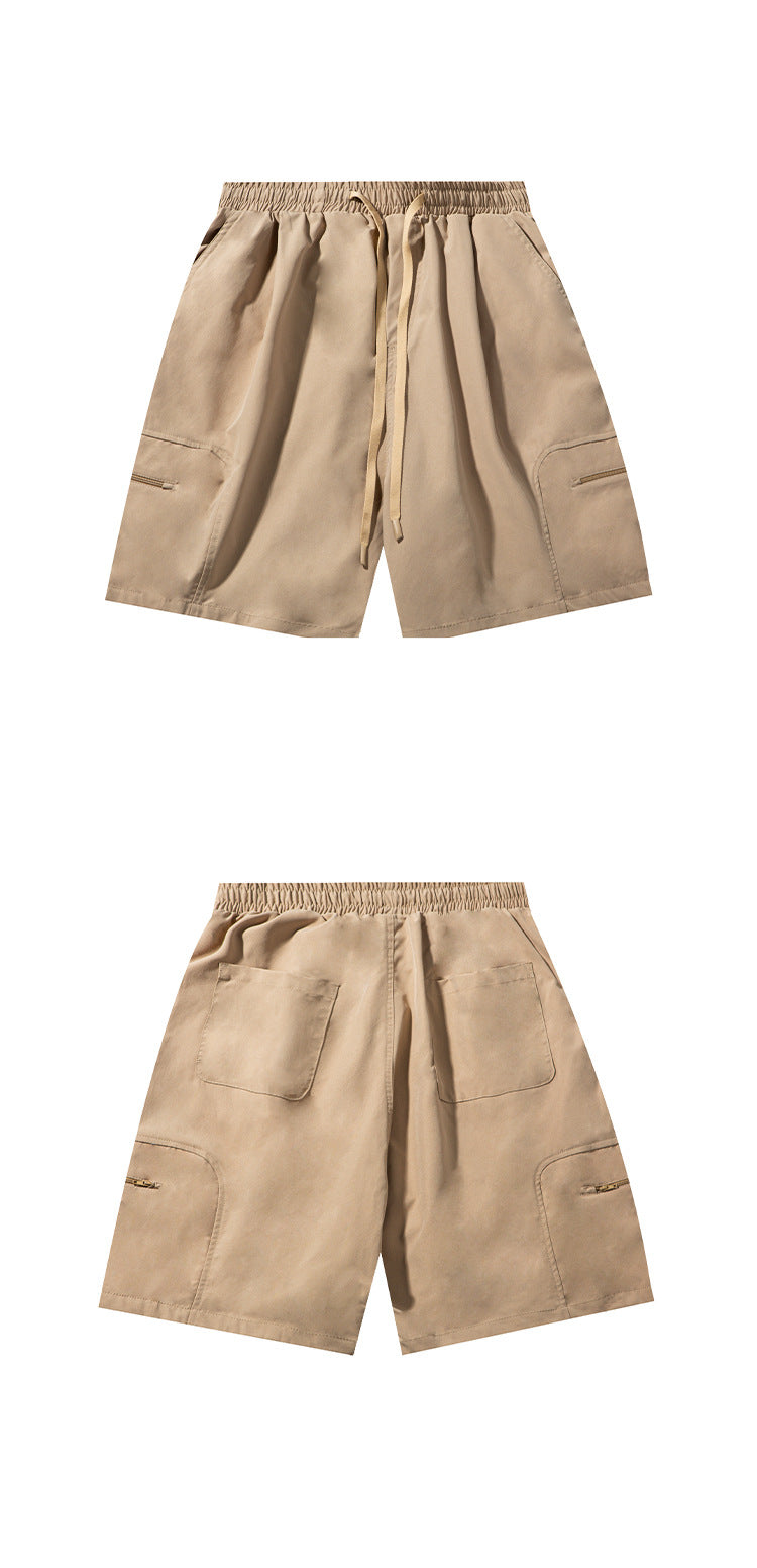 Beige drawstring shorts shown from the front and back, with side zip pockets and rear patch pockets.
