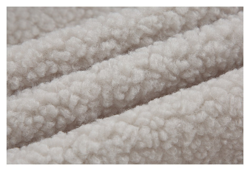 Macro view of the cream jacket's thick, curly sherpa lining.