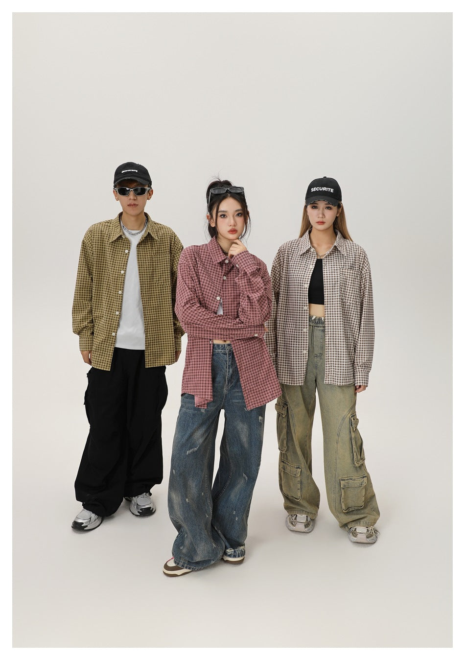 Three models wearing olive, dusty red and beige gingham button-up shirts in a studio