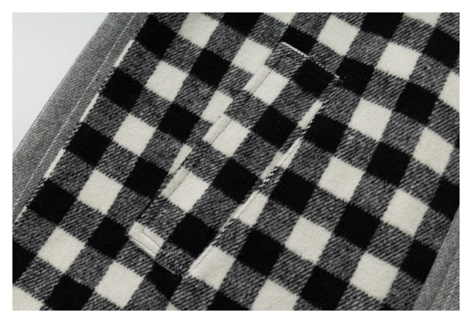 Close-up of black, gray, and white check fabric with stitched openings and a gray edge.