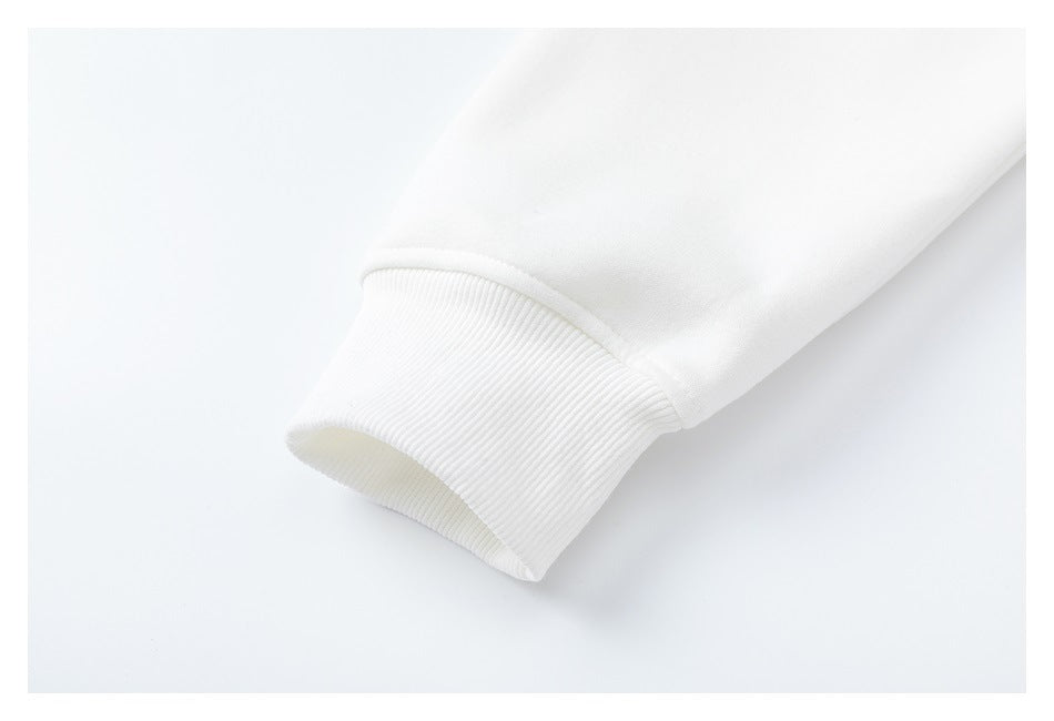 Close-up of a white sweatshirt sleeve ending in a wide ribbed cuff.