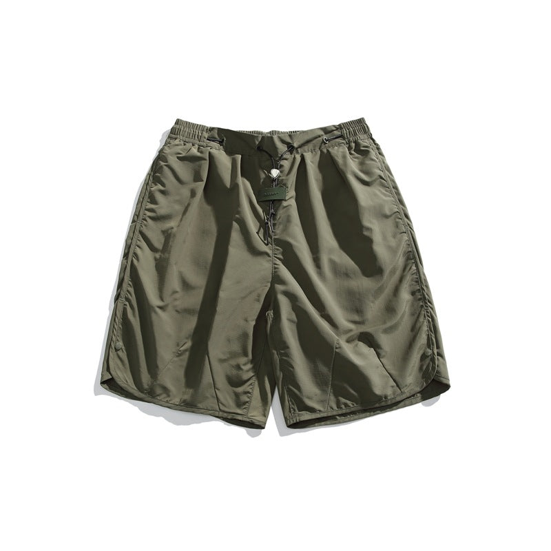 Army green loose shorts with elastic drawcord waist and scalloped side hems, flat lay front view