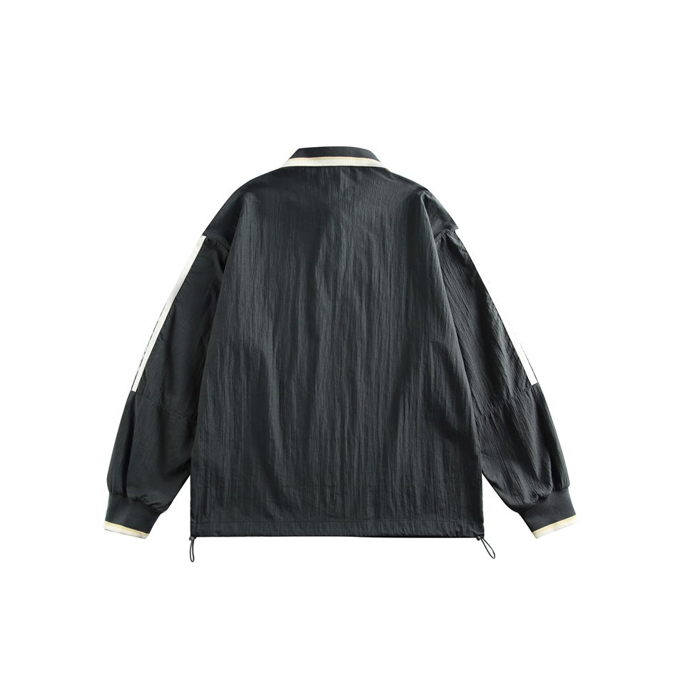 Back view of a black pullover with cream collar and cuff trim, sleeve stripes, and an adjustable drawcord hem.