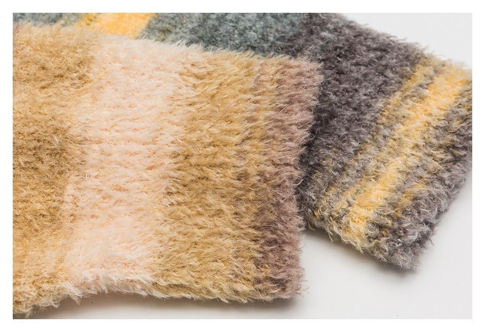Close-up of fuzzy striped sweater fabric in cream, tan, gray, brown, and mustard.