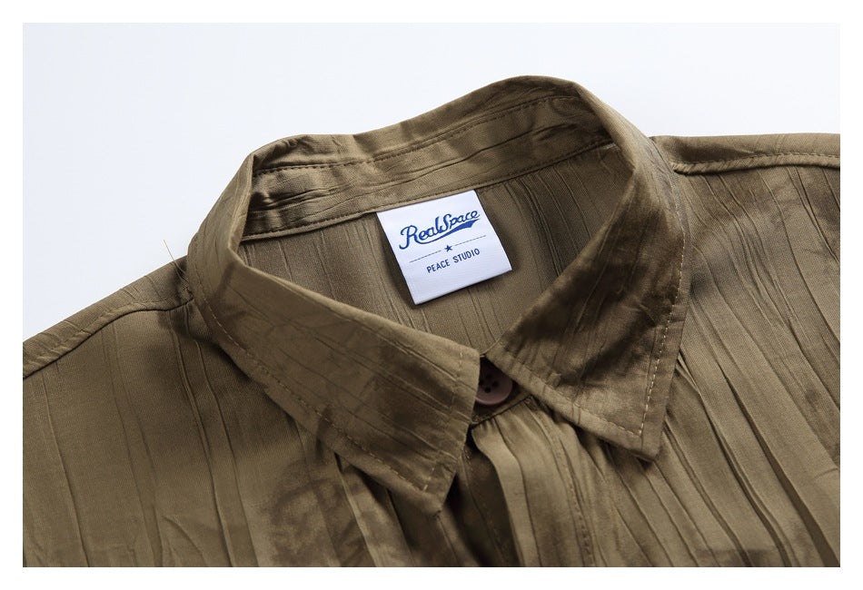 Close-up of a brown abstract-patterned shirt collar with a sewn-in RealSpace label and button.