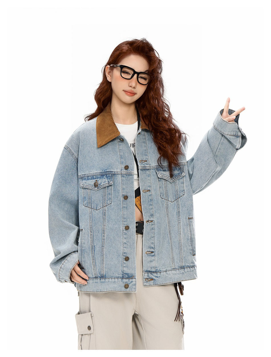 Model in a light-wash oversized denim jacket with a brown collar and flap chest pockets, raising one hand in a peace sign.