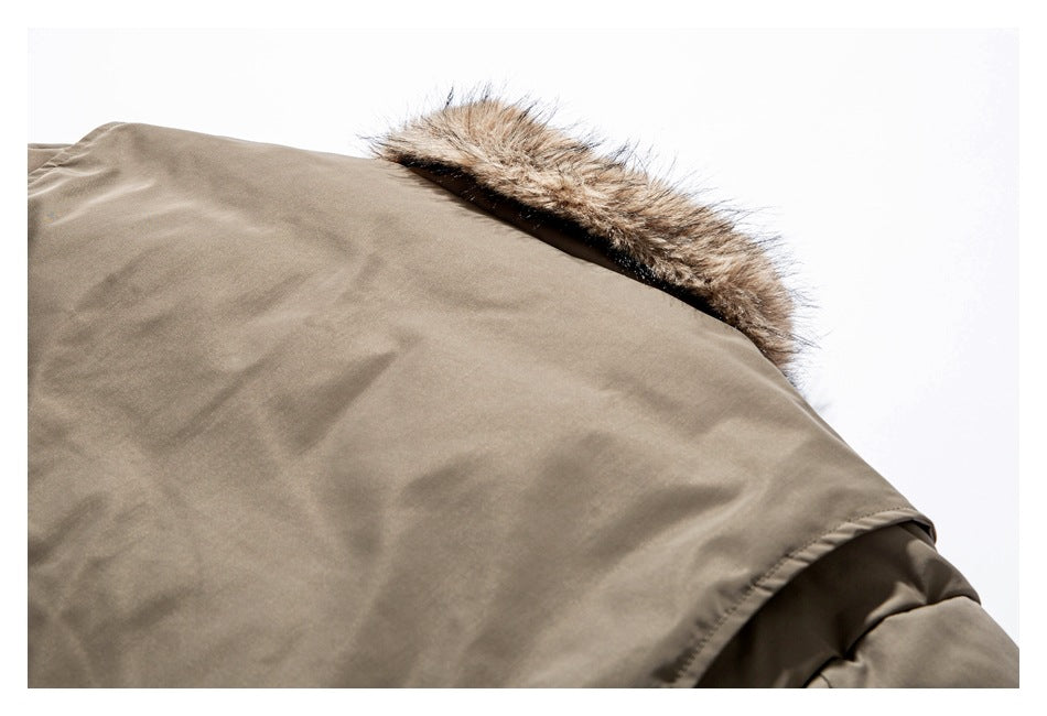Close-up of a taupe jacket hood edged with brown faux-fur trim.