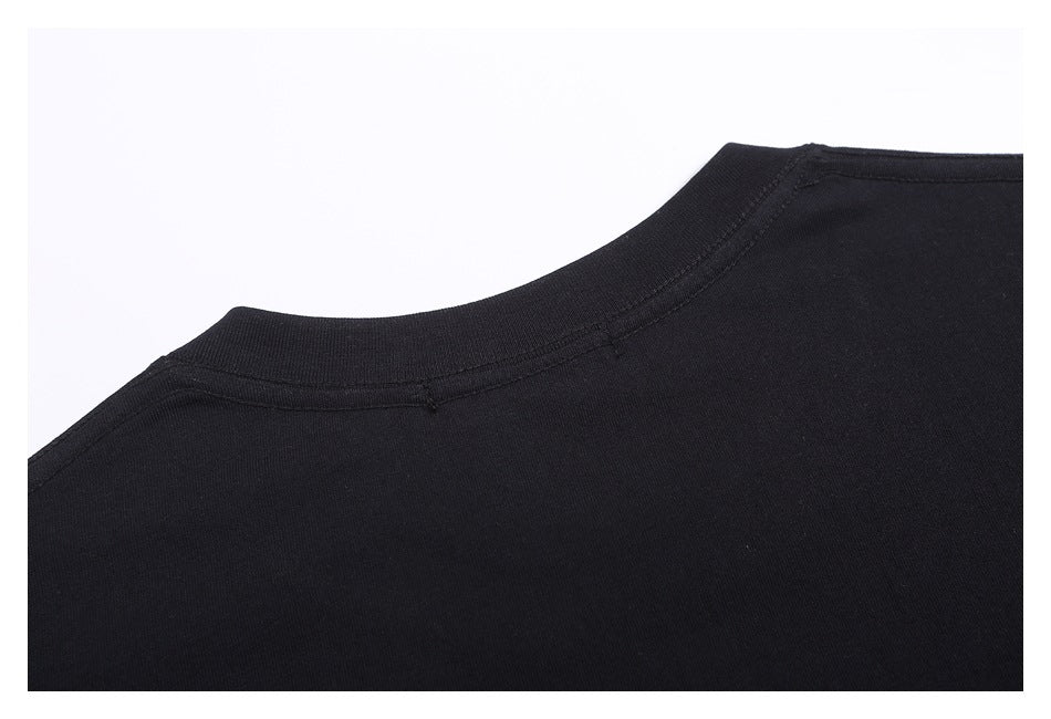 Close-up of the black garment's rounded neckline and shoulder stitching.
