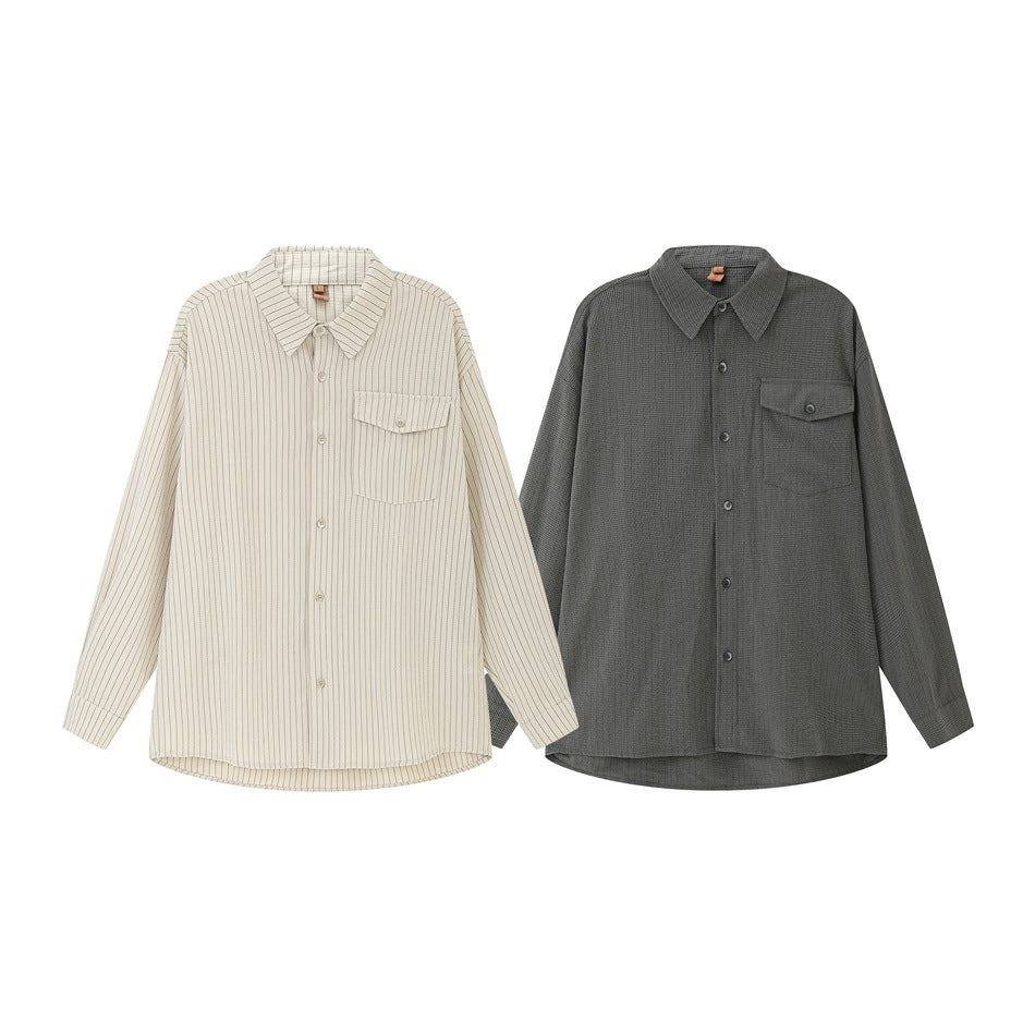 Two long-sleeve button-up shirts shown from the front: ivory with thin stripes and solid charcoal gray.