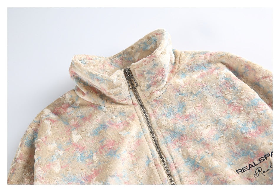 Close-up of the pastel jacket's textured multicolor fabric, high collar, and front zipper.