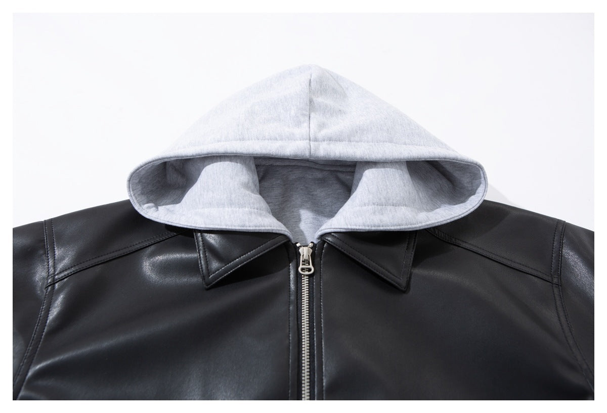 Close-up of a black jacket with a light gray hood, pointed collar panels, and a front zipper.