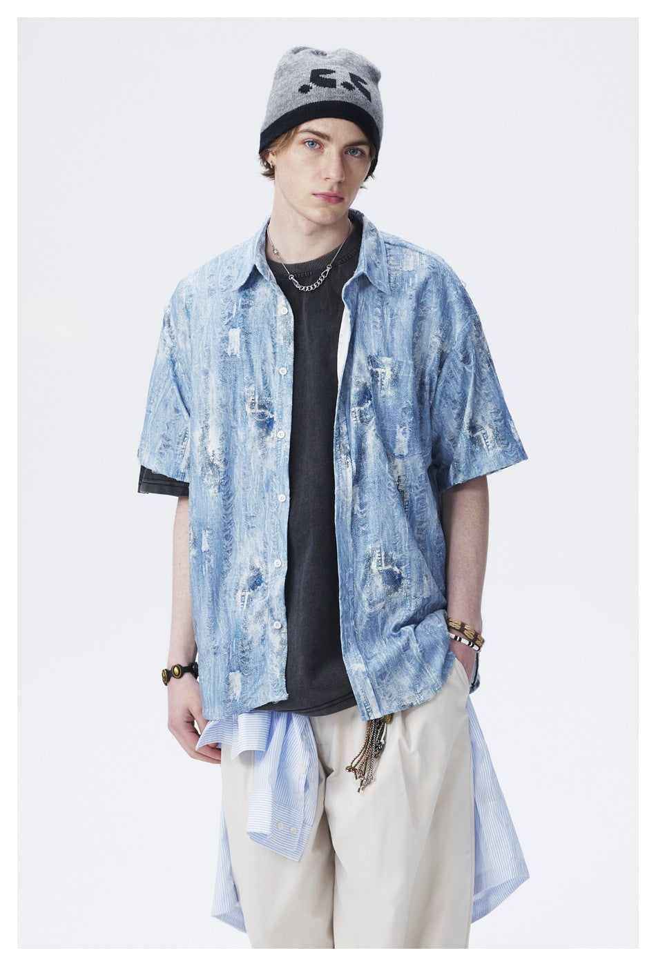 Model wearing a light blue distressed-pattern short-sleeve button-up shirt with a chest pocket.