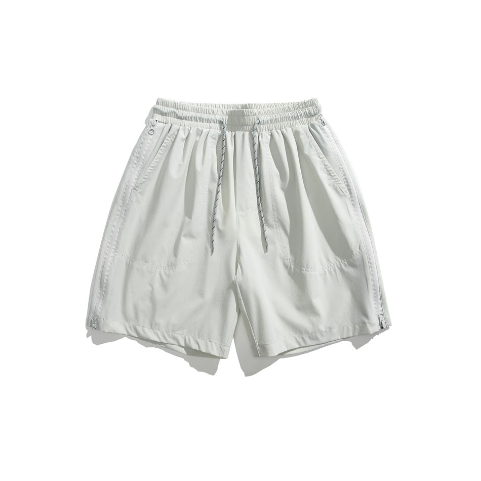 Front view of white shorts with an elastic waistband, drawstrings, and zippered side pockets.