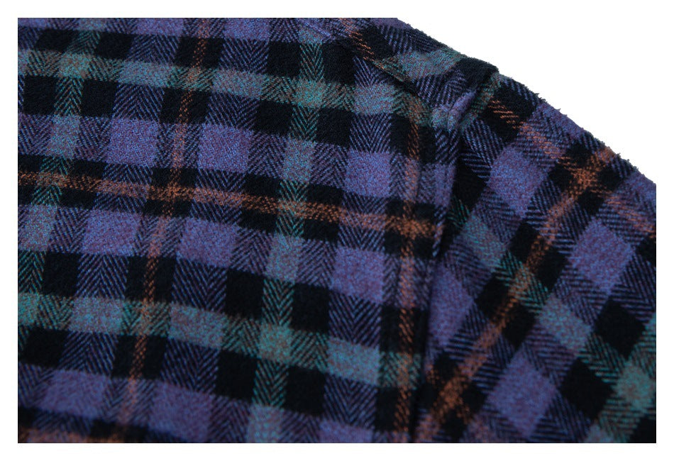 Close-up of a dark plaid shirt shoulder seam with purple, teal, and rust checks.