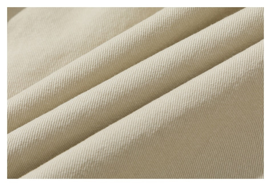 Macro view of the fine diagonal weave and folds of ivory fabric.