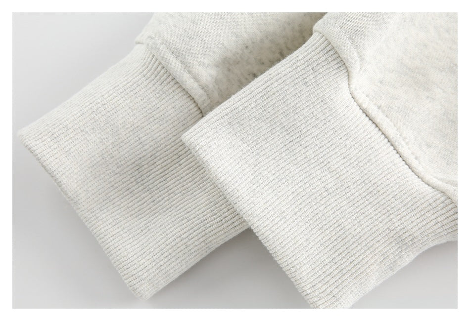 Close-up of two wide ribbed cuffs on a light heather-gray garment.