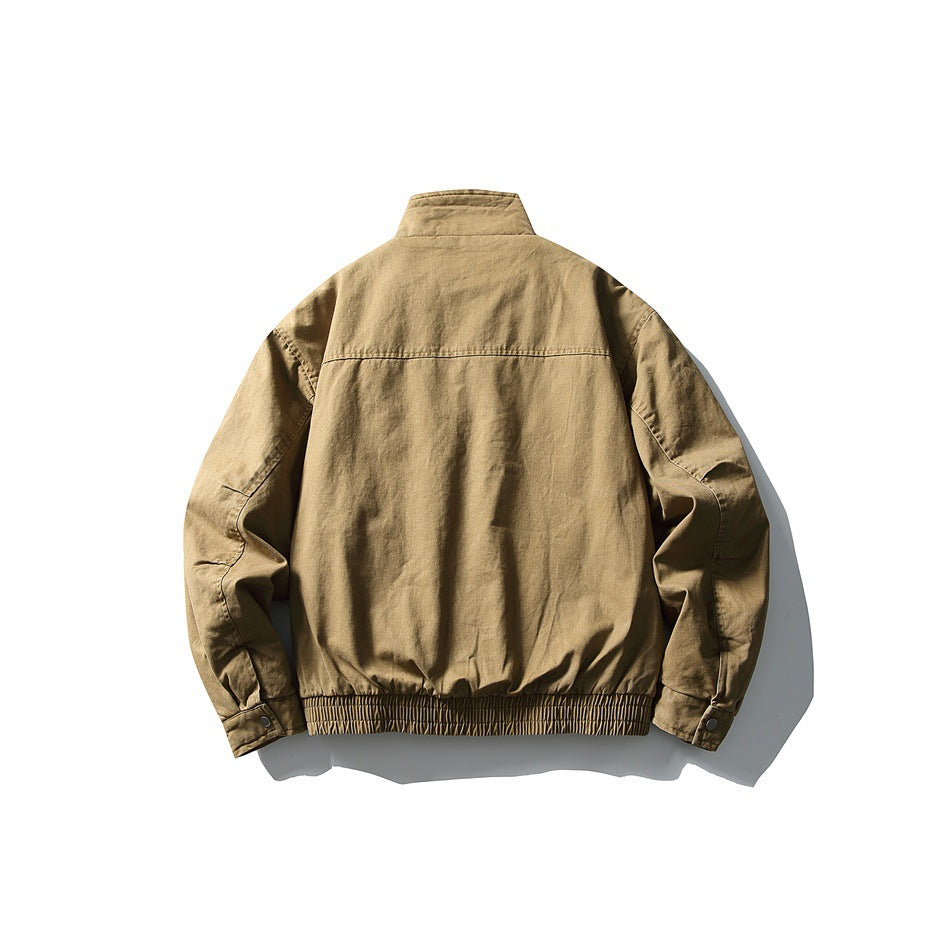 Back view of a tan jacket with a stand collar, long sleeves, buttoned cuffs, and a gathered hem.