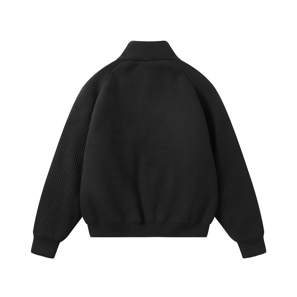 Back view of a black zip-up jacket with a stand collar, smooth body, and ribbed sleeves.