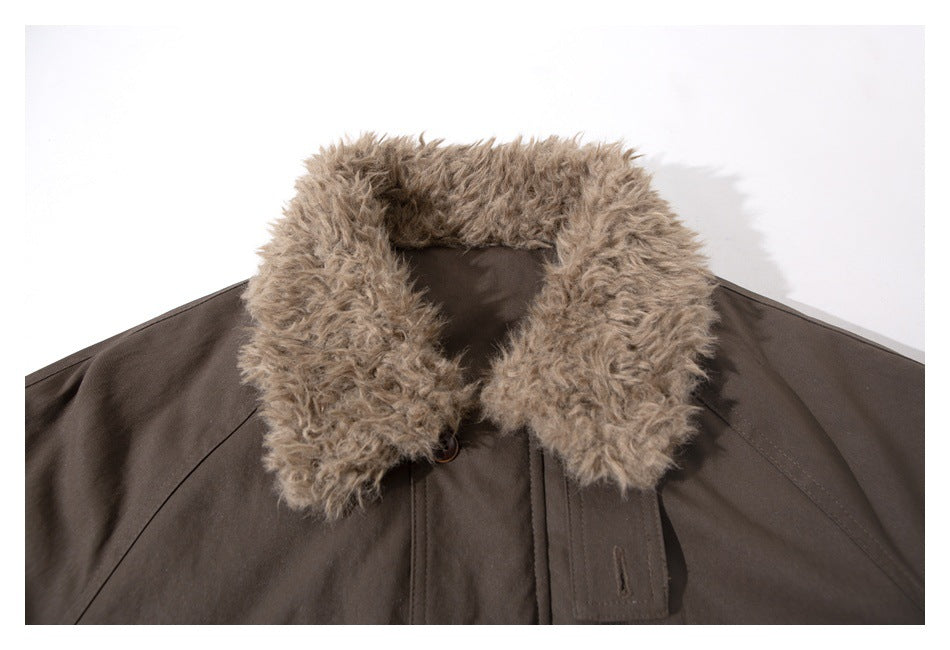 Close-up of a dark brown jacket's shaggy tan collar and front placket.