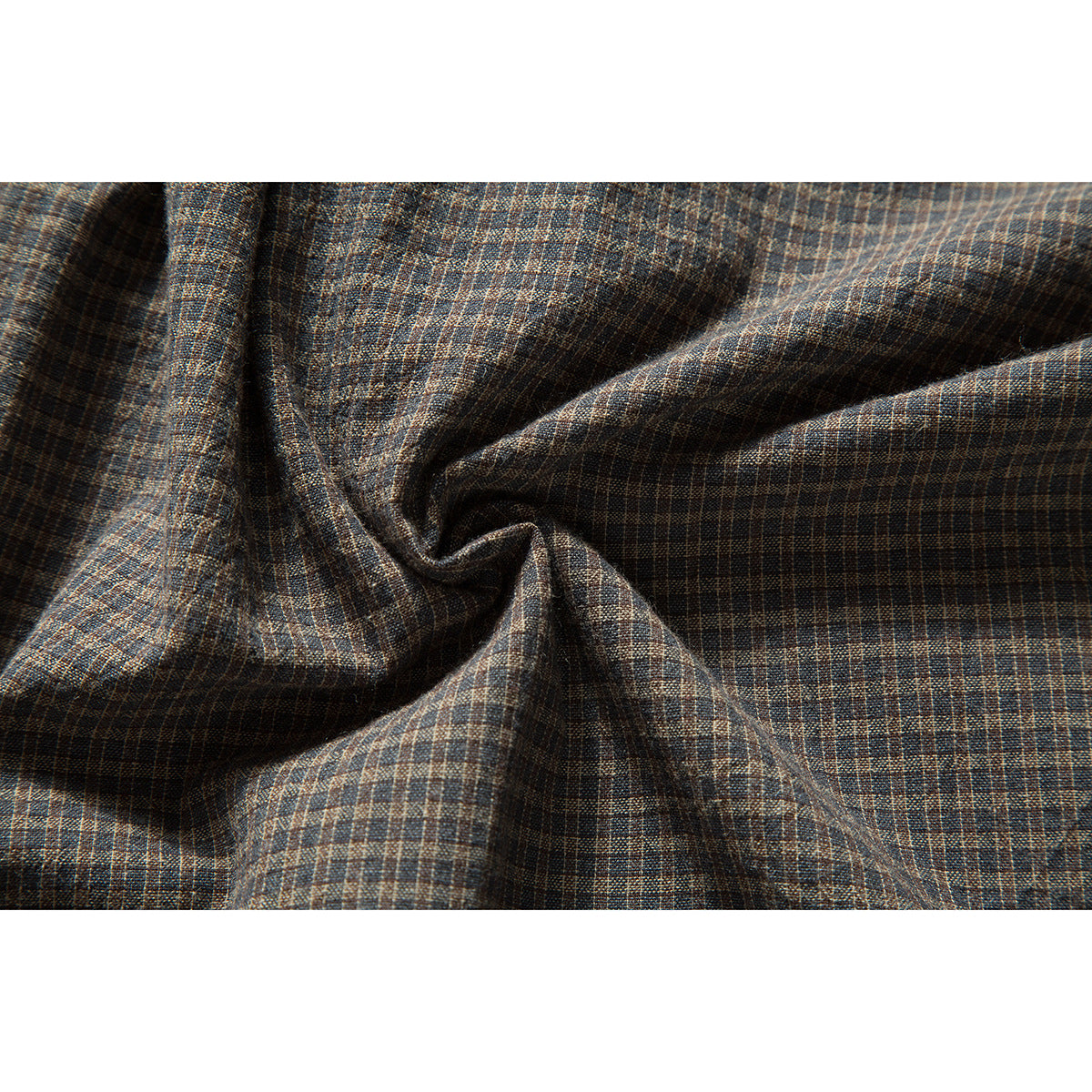 Close-up of brown and blue small-check shirt fabric gathered into folds.