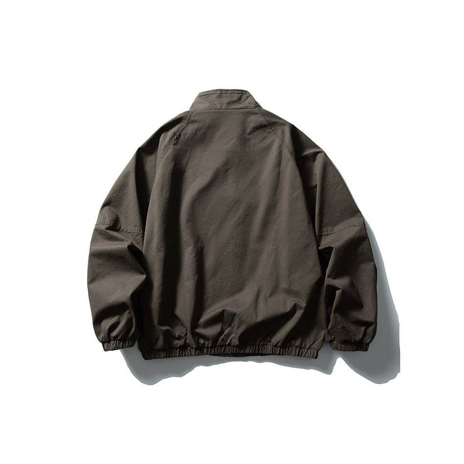 Back view of a dark charcoal-brown jacket with a stand collar, roomy sleeves, elastic cuffs, and a gathered hem.
