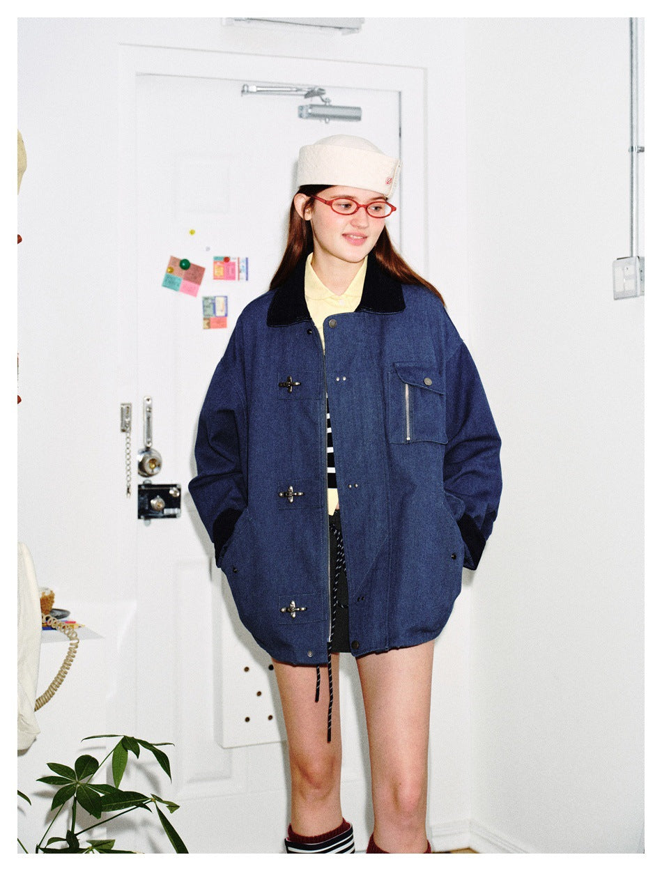 Model wearing a dark blue oversized jacket with a black collar, toggle closures and a zippered flap chest pocket.