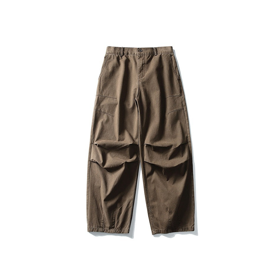 Brown wide-leg trousers flat lay front view with knee pleats and slanted thigh seams