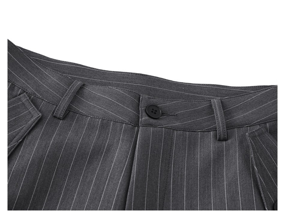 Close-up of the waistband and button closure on charcoal pinstripe trousers.