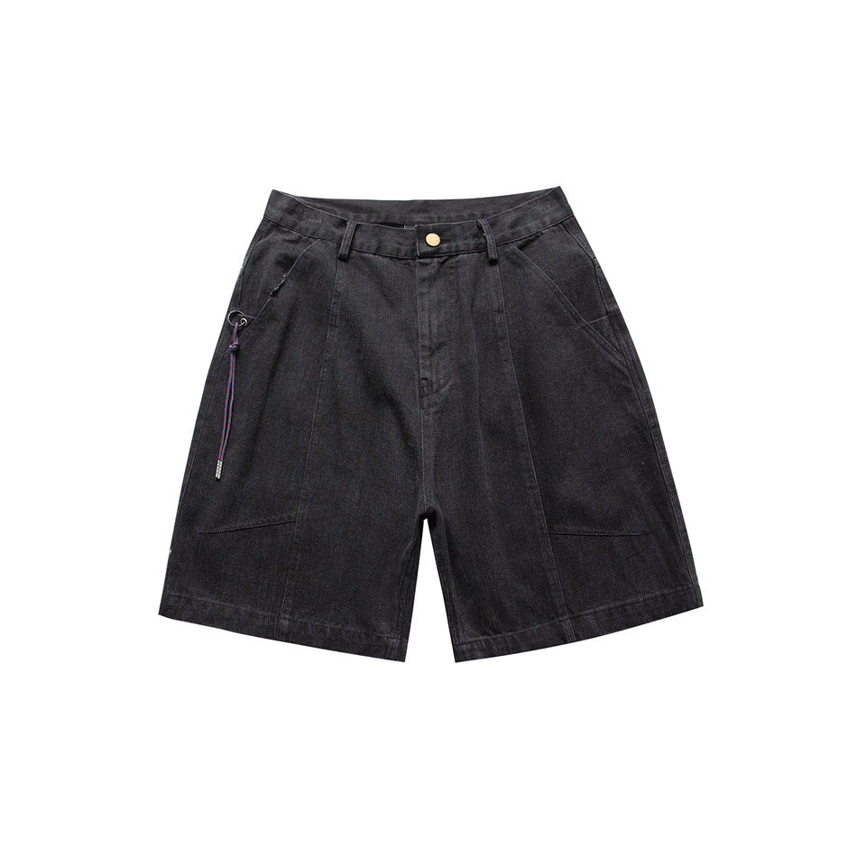 Black washed denim-look knee-length shorts, front view, with button fly, angled pockets and a purple cord on the left hip