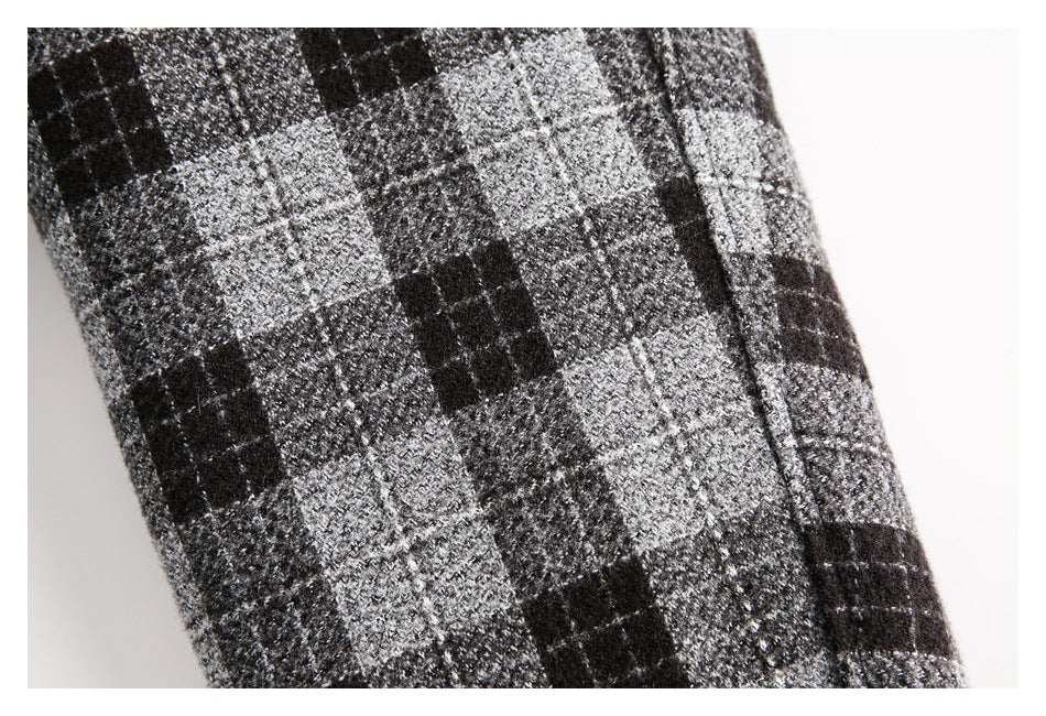 Close-up of a black, charcoal, and gray plaid garment with a fuzzy, textured surface.