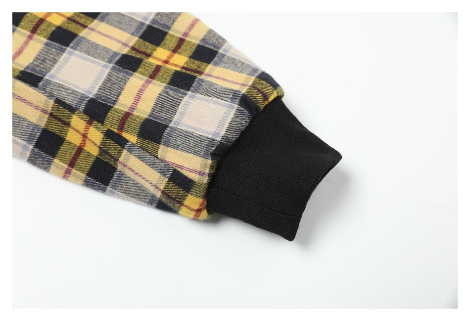 Close-up of the plaid sleeve meeting a black ribbed cuff.