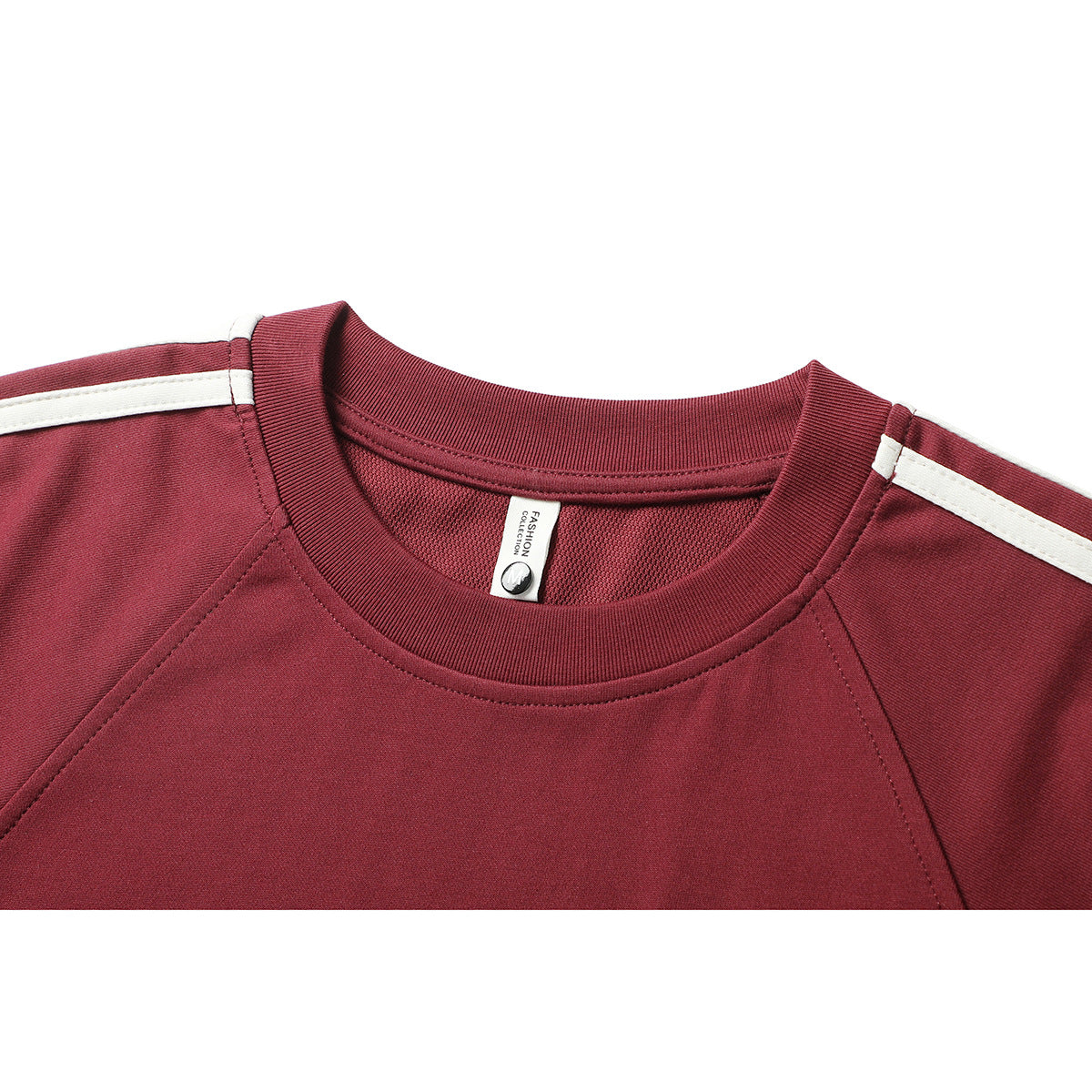 Close-up of a burgundy shirt’s ribbed crew neck, mesh inner panel, white shoulder stripes and sewn neck label.