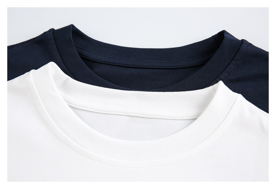 Close-up of white and navy crewneck shirts showing their ribbed collars.