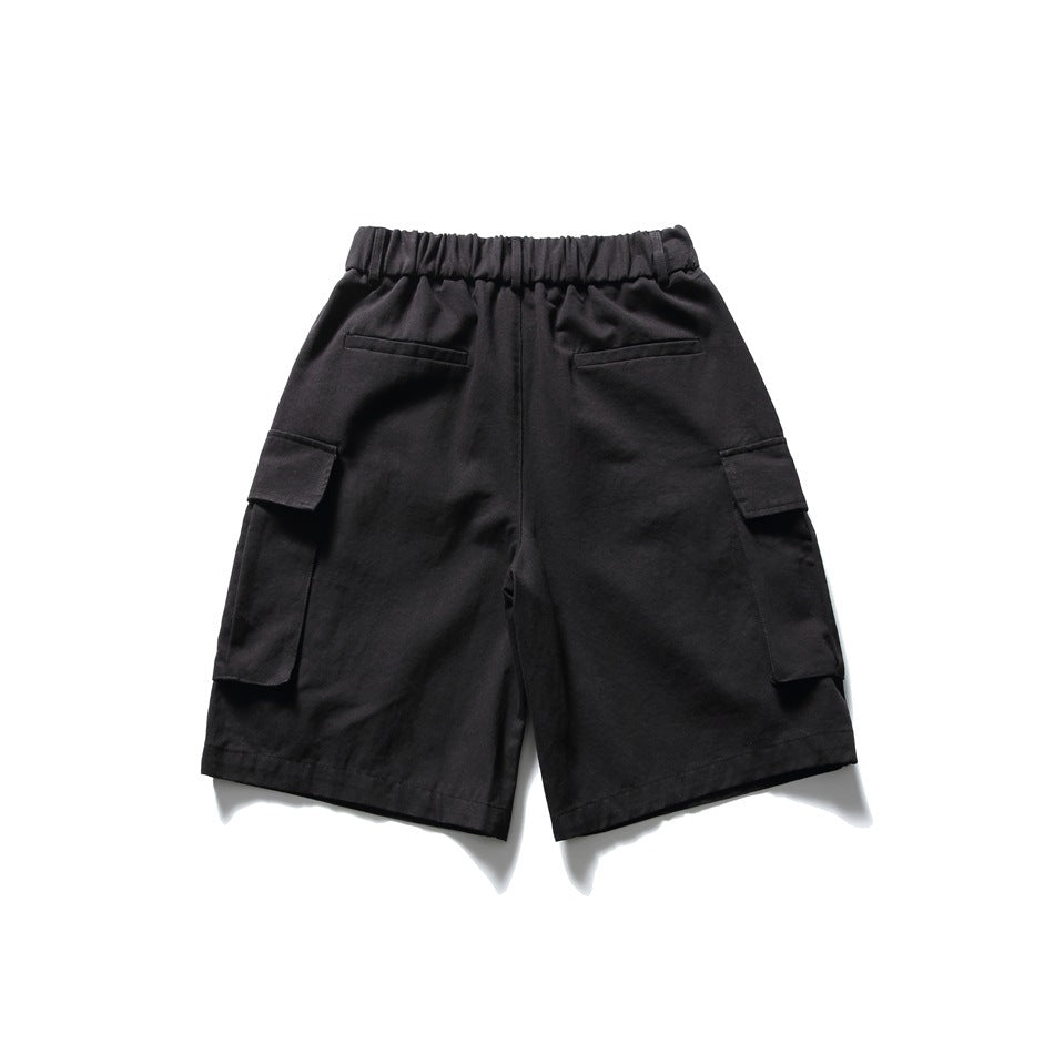 Black cargo shorts back view with elastic waistband, two welt back pockets and large flap side pockets