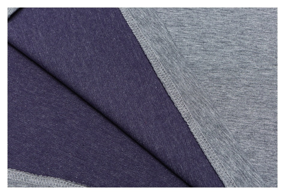 Close-up of the shirt's dark purple inner fabric and gray overlock seam.