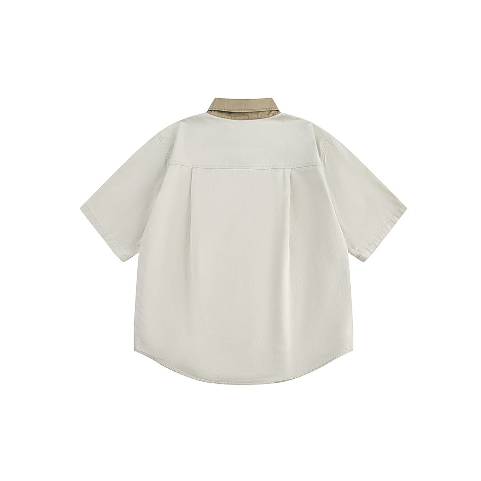 Back view of an ivory short-sleeve shirt with a contrasting tan collar and curved hem.