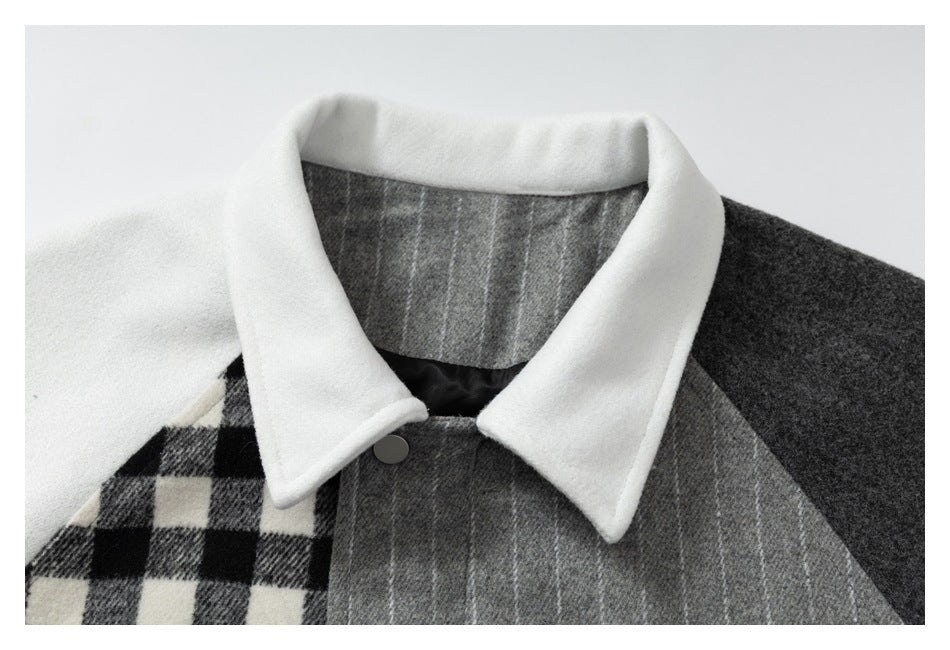Close-up of the jacket's white pointed collar, gray pinstriped front, black-and-white checked panel, and snap closure.