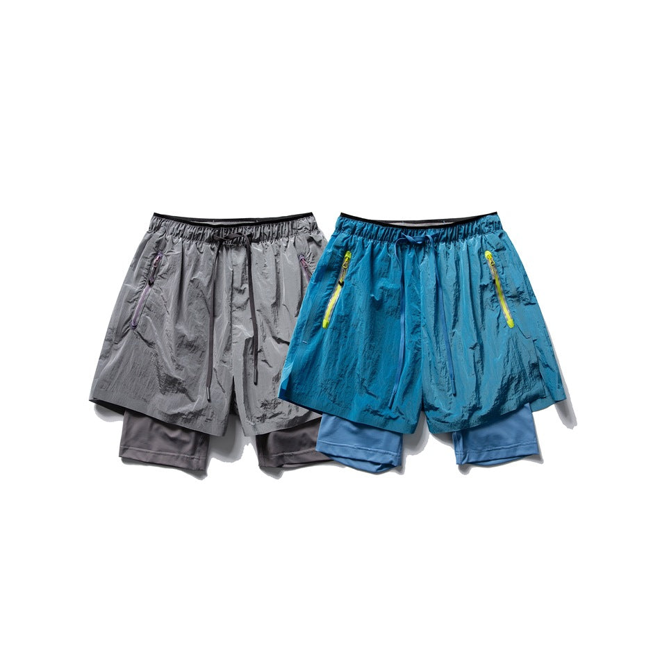 Two pairs of layered running shorts shown together: gray with purple zipper trim and blue with yellow trim.