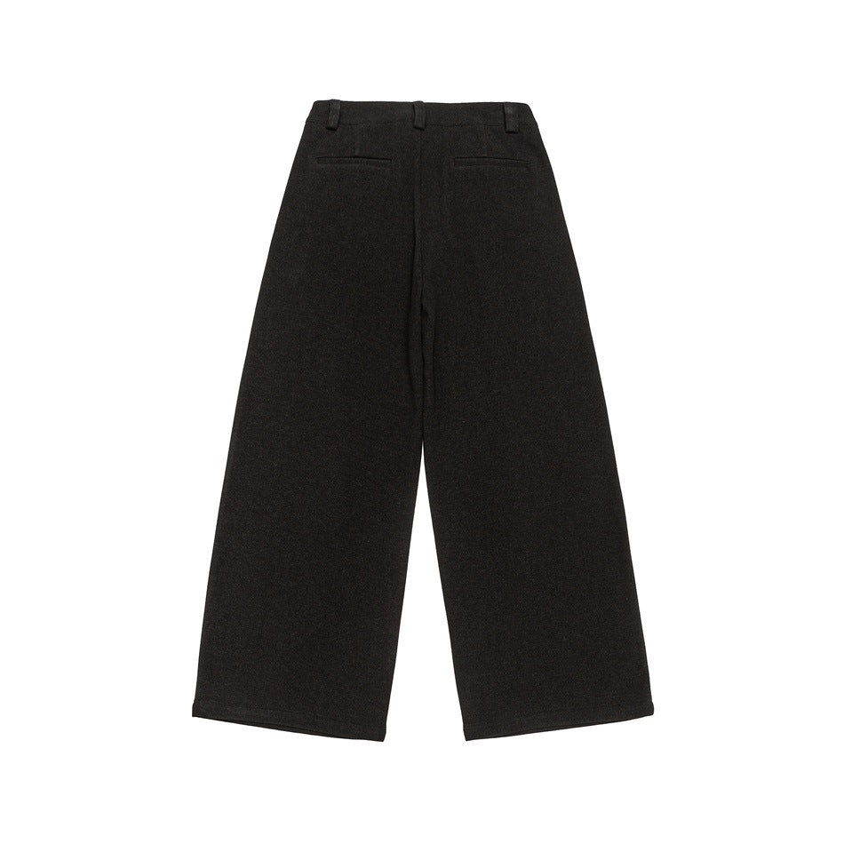 Back view of dark charcoal wide-leg trousers with belt loops and two welt pockets.