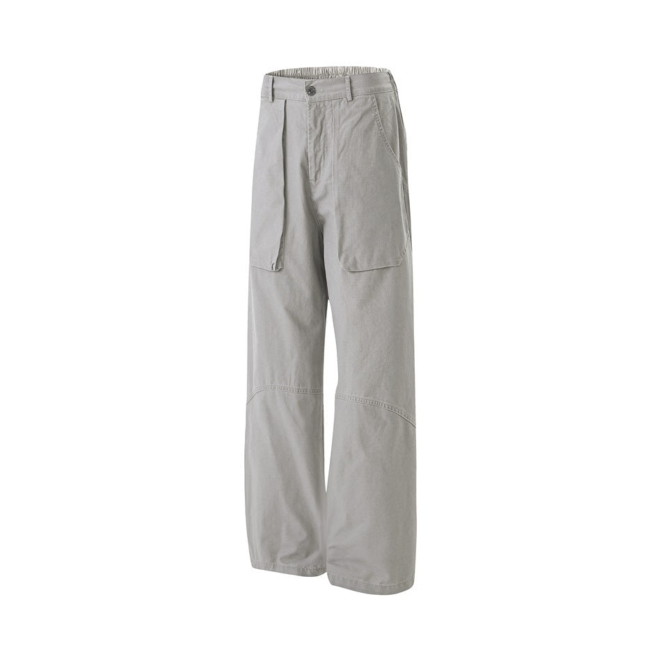 Full front view of light gray wide-leg trousers with large front patch pockets and a button waist, on white.
