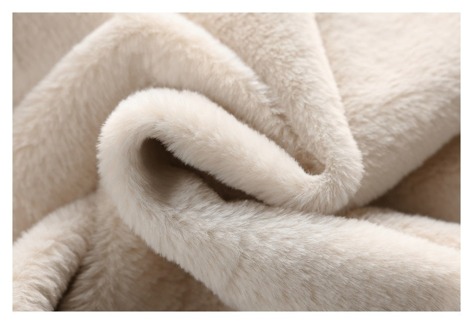 Close-up showing the soft, fluffy cream pile and folded edge of a garment.