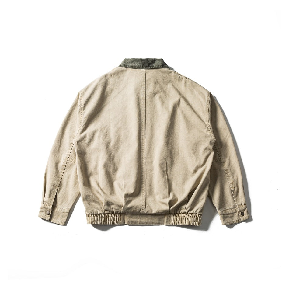 Back view of khaki jacket with olive green collar, center back seam, elastic hem band and button cuffs, flat lay