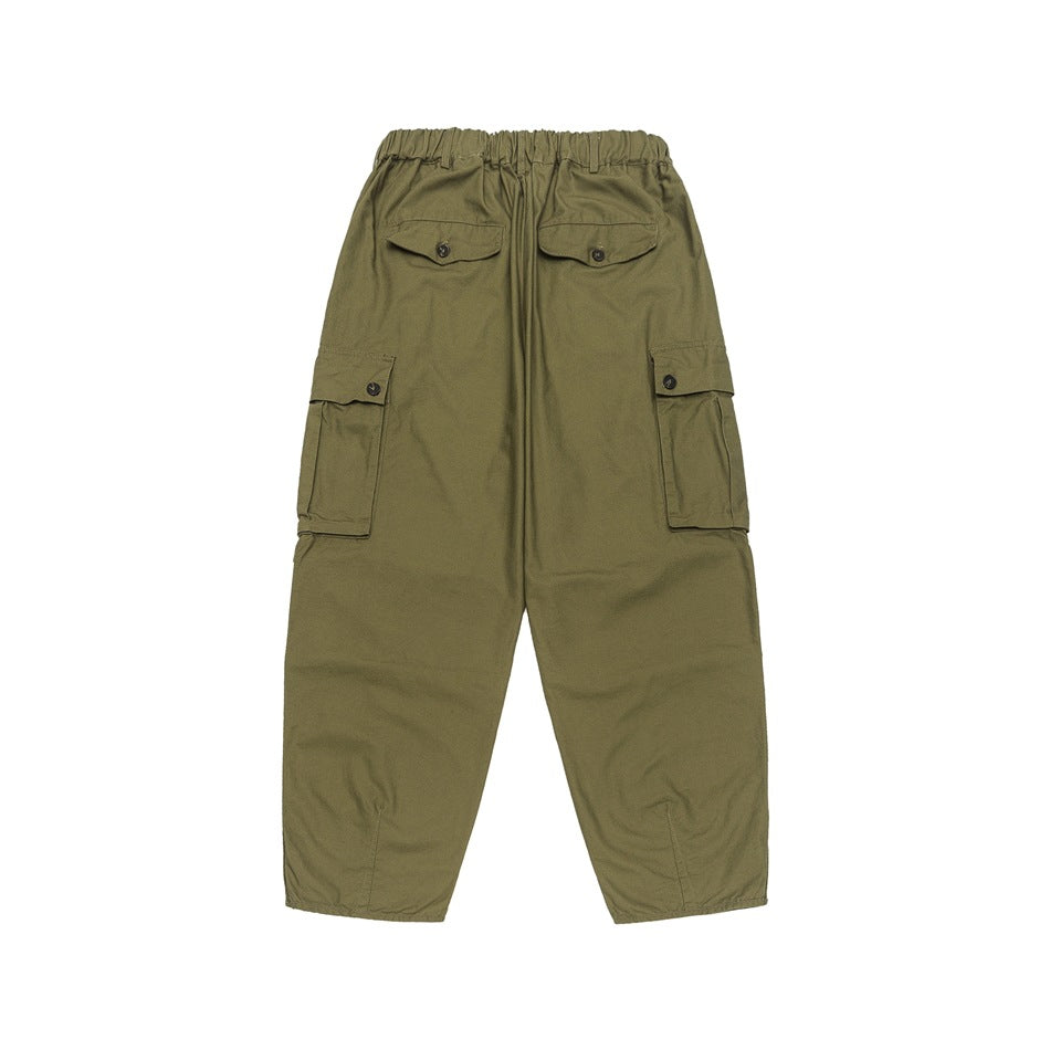 Back view of olive green cargo pants showing two button-flap back pockets, side cargo pockets and elastic waistband