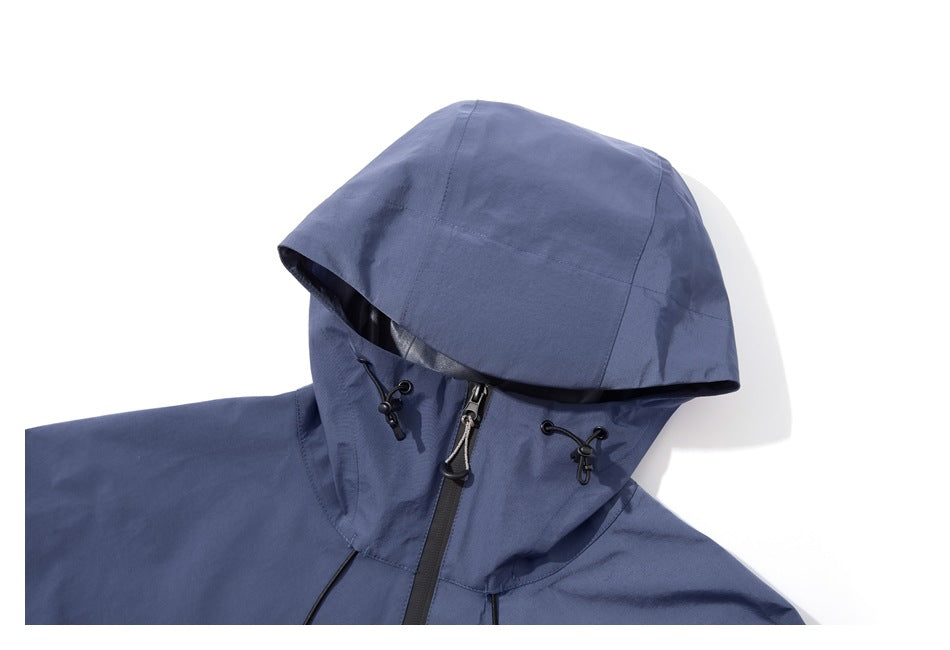 Front view of a slate-blue jacket upper section with a large hood, black drawcord toggles, and front zipper.